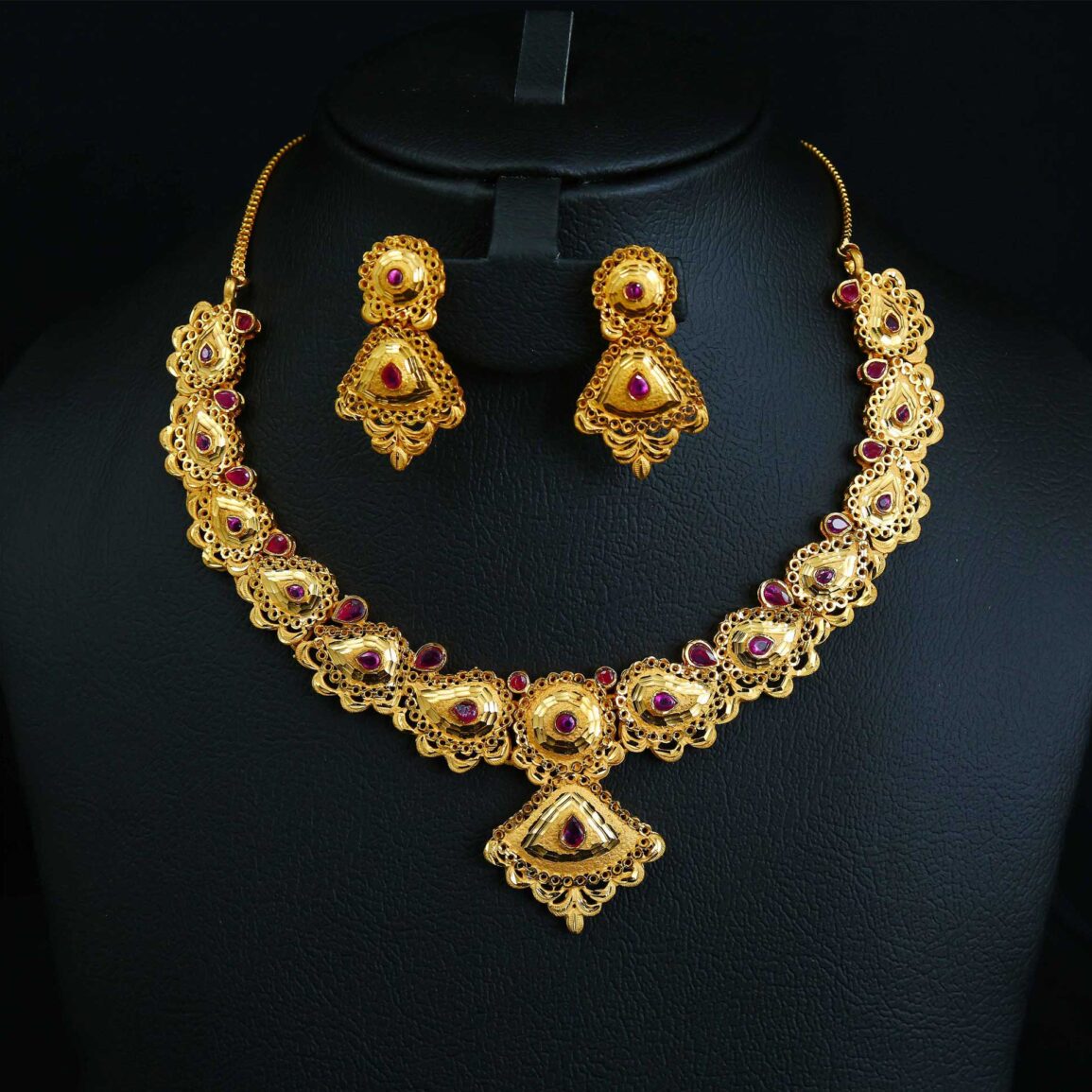 Gold plated necklace set with red stone flower design